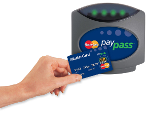 Someone tapping their credit card on MasterCard PayPass reader.