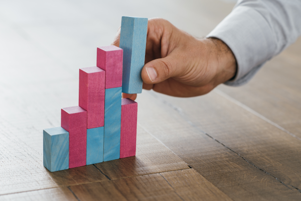 A guy building a graph with blocks representing how to establish and get credit.