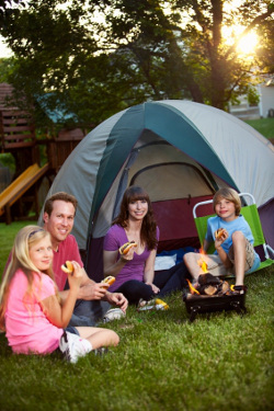 A family camping in their backyard as part of their staycation.