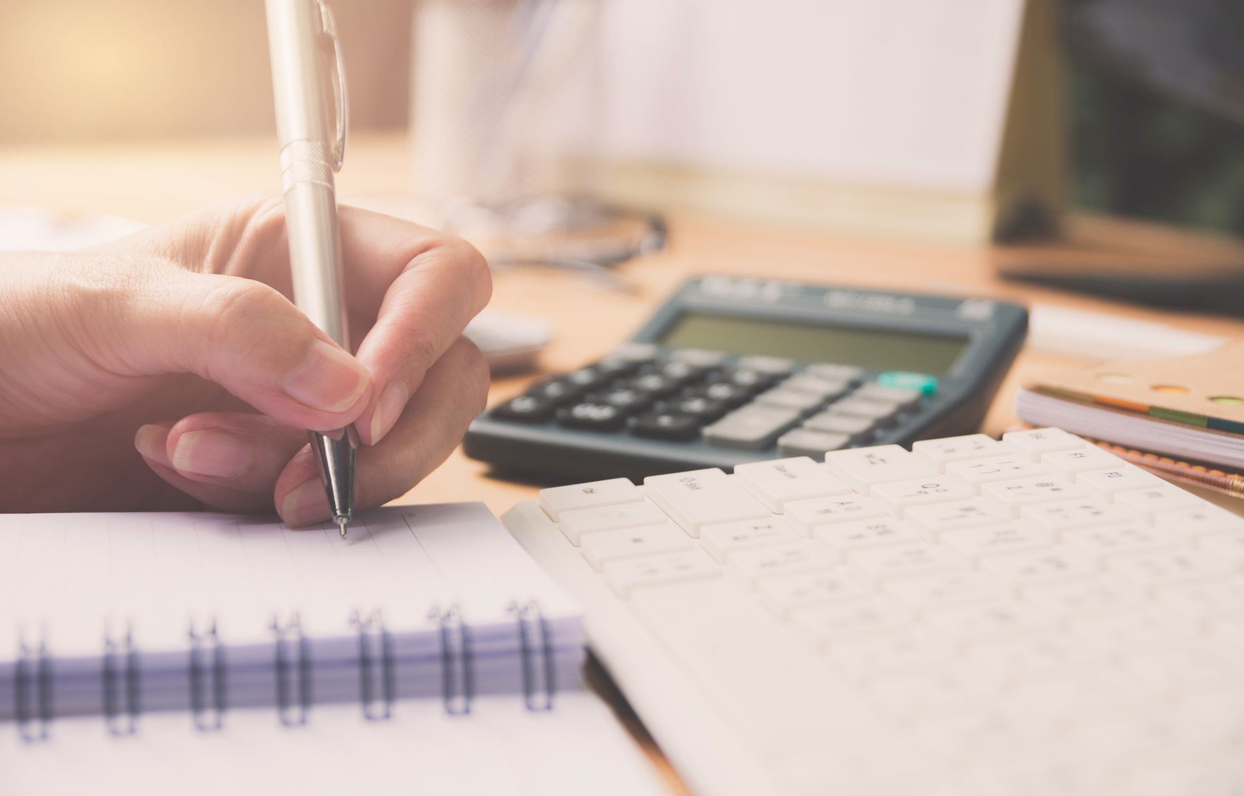 Someone doing their taxes and taking notes about what to do if they owe CERB taxes.