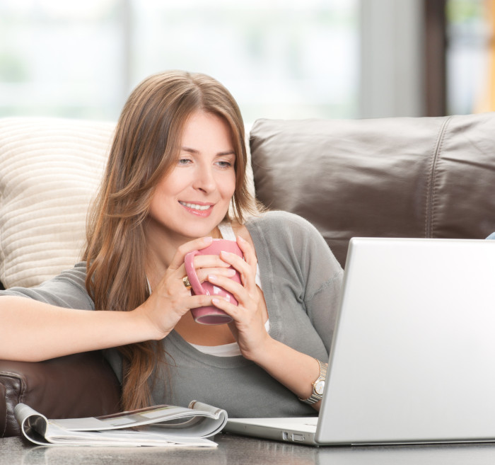 Woman at home taking part in an online workshop on her laptop.