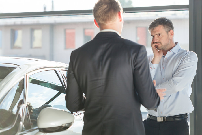 Semi-opaque colour over image of guy buying a car.